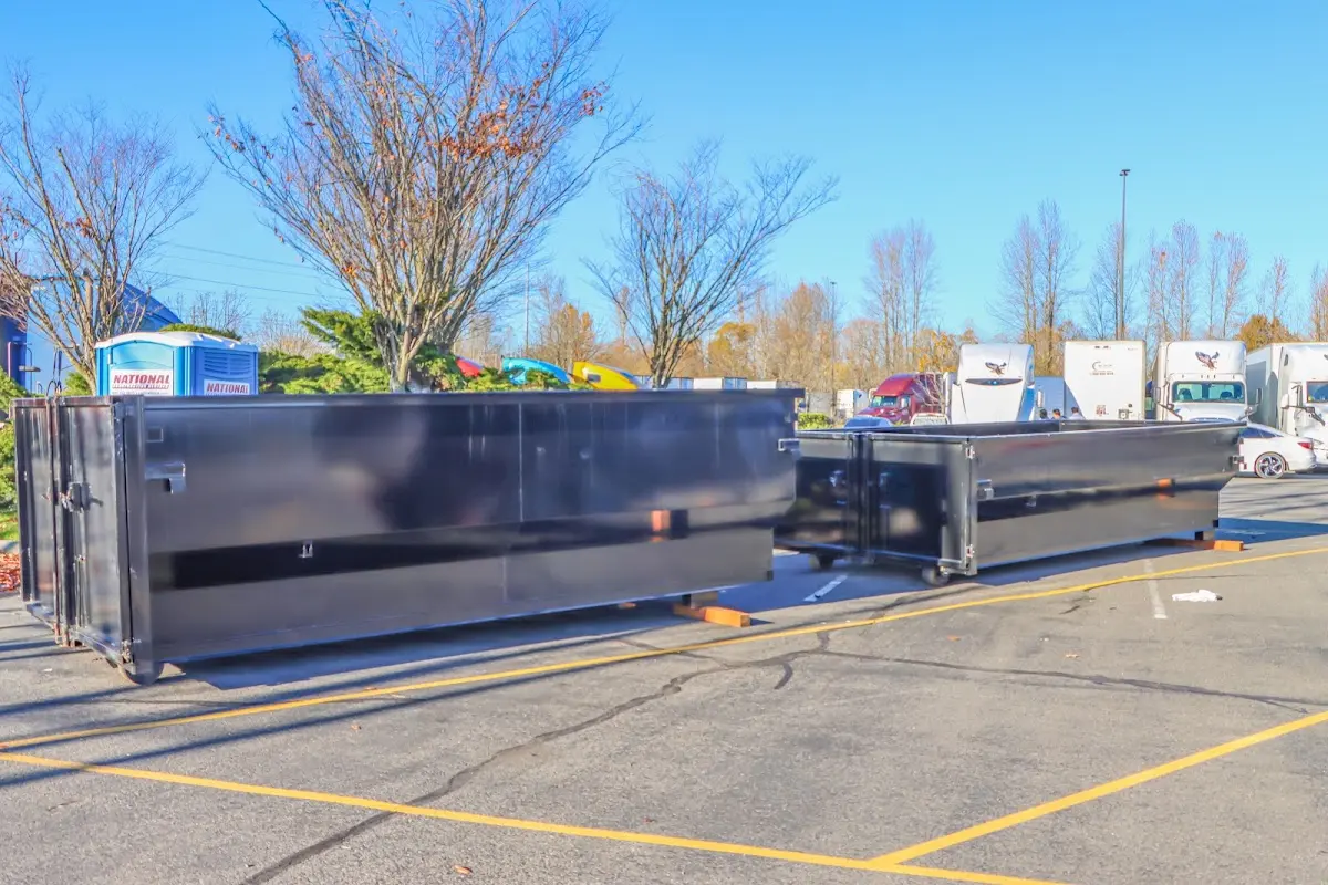 Professional dumpster rental service with roll-off container on residential driveway in Fairhaven